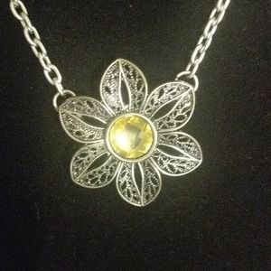 Intricate silver flower necklace with yellow jewel